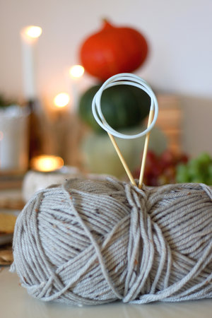 Pumpkins, various food and drinks, fall decorations, books and candles on the table. Fall hygge at home. Selective focus.の写真素材