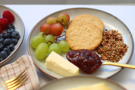 Assortment of various breakfast foods on the white table. Selective focus.の写真素材