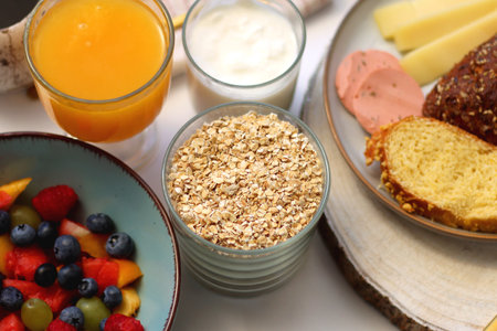 Assortment of various breakfast foods and drinks on the white table. Selective focus.の写真素材