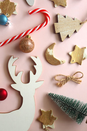 Various cute Christmas ornaments on pale pink background. Flat lay.の写真素材