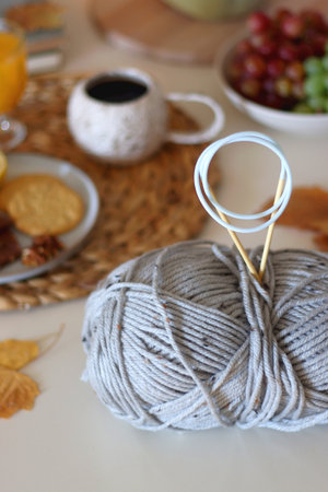 Pumpkins, various food and drinks, fall decorations, books and candles on the table. Fall hygge at home. Selective focus.の写真素材
