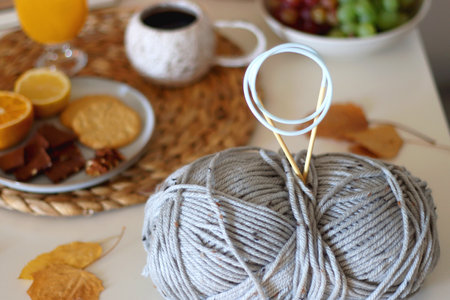 Pumpkins, various food and drinks, fall decorations, books and candles on the table. Fall hygge at home. Selective focus.の写真素材