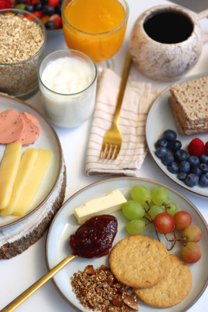 Assortment of various breakfast foods and drinks on the white table. Selective focus.の写真素材