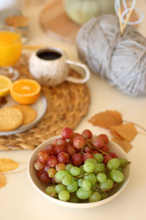 Pumpkins, various food and drinks, fall decorations, books and candles on the table. Fall hygge at home. Selective focus.の写真素材