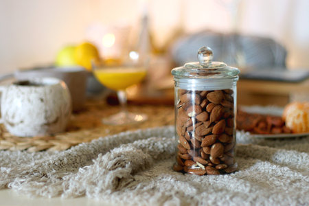 Books, tea, orange juice, fruit, snacks, blanket and lit candles on the table. Autumn or winter hygge at home. Selective focus.の写真素材