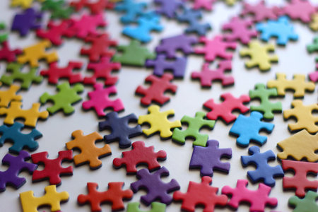Colorful jigsaw puzzle pieces on white background. Selective focus.の写真素材