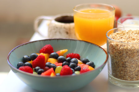 Assortment of various breakfast foods and drinks on the white table. Selective focus.の写真素材