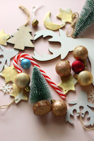 Various cute Christmas ornaments on pale pink background. Selective focus.の写真素材