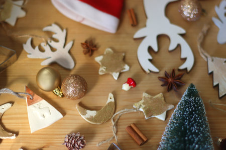 Various Christmas decorations in neutral colors on wooden background. Selective focus.の写真素材
