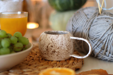 Pumpkins, various food and drinks, fall decorations, books and candles on the table. Fall hygge at home. Selective focus.の写真素材