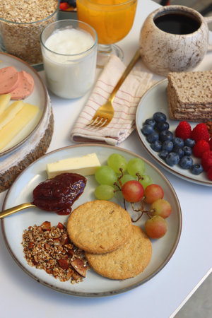 Assortment of various breakfast foods and drinks on the white table. Selective focus.の写真素材