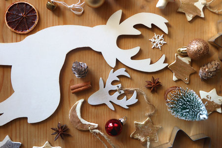 Various Christmas decorations in neutral colors on wooden background. Flat lay.の写真素材