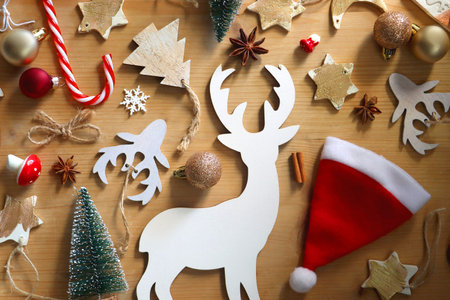 Various Christmas decorations in neutral colors on wooden background. Flat lay.の写真素材