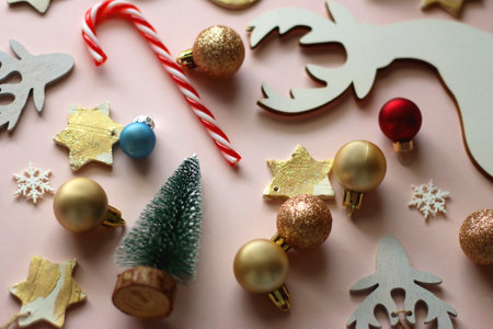 Various cute Christmas ornaments on pale pink background. Selective focus.の写真素材