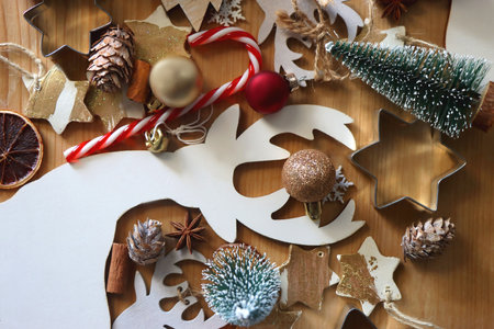 Various Christmas decorations in neutral colors on wooden background. Flat lay.の写真素材