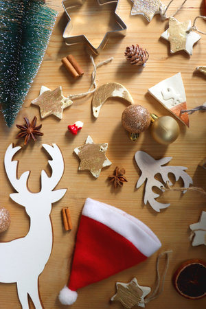 Various Christmas decorations in neutral colors on wooden background. Flat lay.の写真素材
