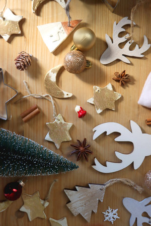 Various Christmas decorations in neutral colors on wooden background. Flat lay.の写真素材