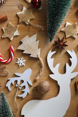 Various Christmas decorations in neutral colors on wooden background. Flat lay.の写真素材