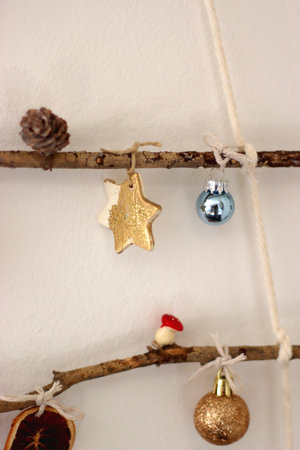 Cute Christmas tree ornaments, hanging on the branches. Selective focus.の写真素材