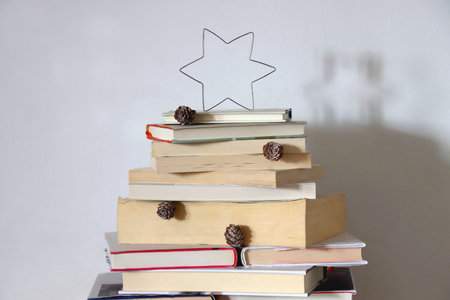 Christmas tree made with stack of books. Cute Christmas tree for booklovers. Selective focus.の写真素材