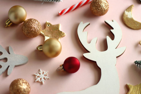 Various cute Christmas ornaments on pale pink background. Selective focus.の写真素材