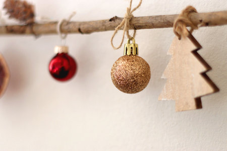 Cute Christmas tree ornaments, hanging on the branches. Selective focus.の写真素材