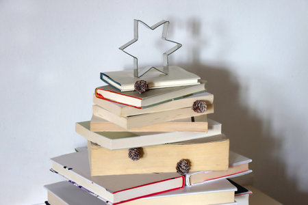 Christmas tree made with stack of books. Cute Christmas tree for booklovers. Selective focus.の写真素材