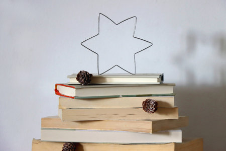 Christmas tree made with stack of books. Cute Christmas tree for booklovers. Selective focus.の写真素材