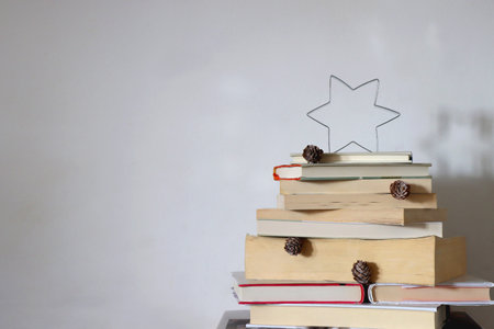 Christmas tree made with stack of books. Cute Christmas tree for booklovers. Selective focus.の写真素材