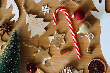 Various Christmas decorations in neutral colors on wooden background. Flat lay.の写真素材