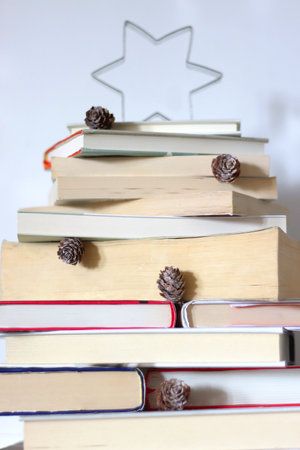Christmas tree made with stack of books. Cute Christmas tree for booklovers. Selective focus.の写真素材