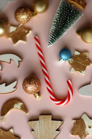 Various cute Christmas ornaments on pale pink background. Selective focus.の写真素材