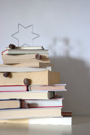 Christmas tree made with stack of books. Cute Christmas tree for booklovers. Selective focus.の写真素材