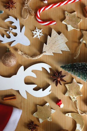 Various Christmas decorations in neutral colors on wooden background. Flat lay.の写真素材