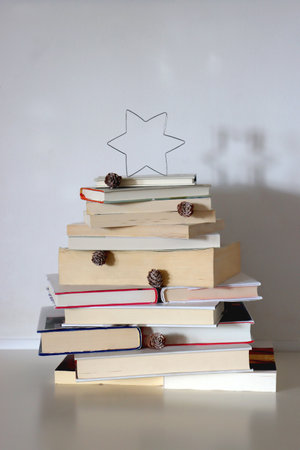 Christmas tree made with stack of books. Cute Christmas tree for booklovers. Selective focus.の写真素材