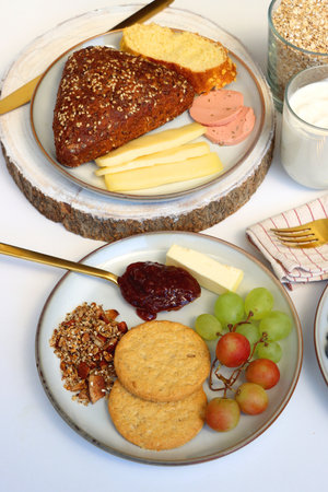 Assortment of various breakfast foods and drinks on the white table. Selective focus.の写真素材