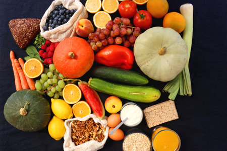 Various healthy fruits, vegetables and cereals on dark background. Top view.の写真素材