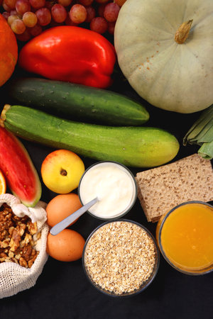 Various healthy fruits, vegetables and cereals on dark background. Top view.の写真素材