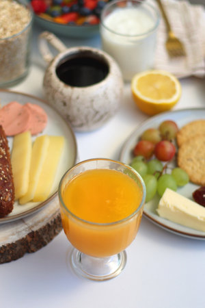 Assortment of various breakfast foods and drinks on the white table. Selective focus.の写真素材