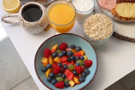 Assortment of various breakfast foods and drinks on the white table. Selective focus.の写真素材