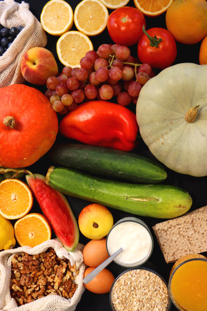 Various healthy fruits, vegetables and cereals on dark background. Top view.の写真素材