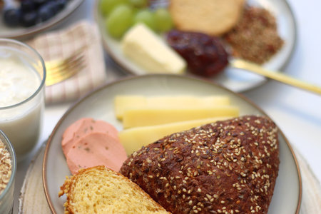 Assortment of various breakfast foods and drinks on the white table. Selective focus.の写真素材