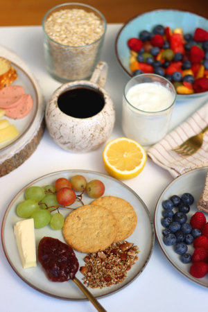Assortment of various breakfast foods and drinks on the white table. Selective focus.の写真素材