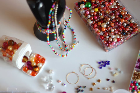 Colorful bead jewelry, statement rings and various hair accessories on the white table. Selective focus.の写真素材