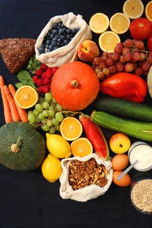 Various healthy fruits, vegetables and cereals on dark background. Top view.の写真素材