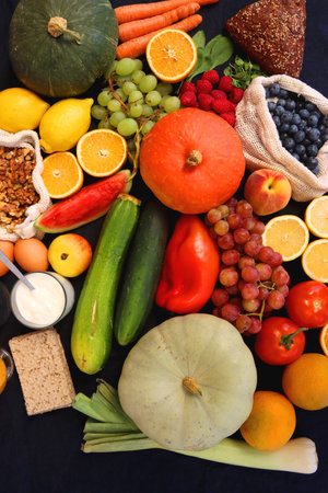 Various healthy fruits, vegetables and cereals on dark background. Top view.の写真素材