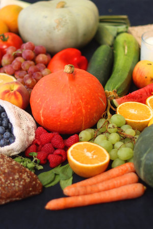 Various healthy fruits, vegetables and cereals on dark background. Selective focus.の写真素材