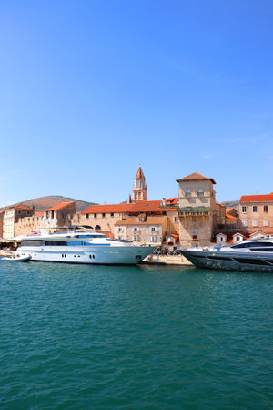 Beautiful old buildings, boats and yachts on the promenade in Trogir, Croatia. Sunny summer day in Trogir.の写真素材