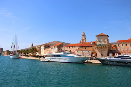 Beautiful old buildings, boats and yachts on the promenade in Trogir, Croatia. Sunny summer day in Trogir.の写真素材