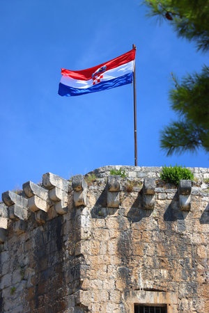Historical Kamerlengo Fortress in Trogir, Croatia and Croatian flag.の写真素材